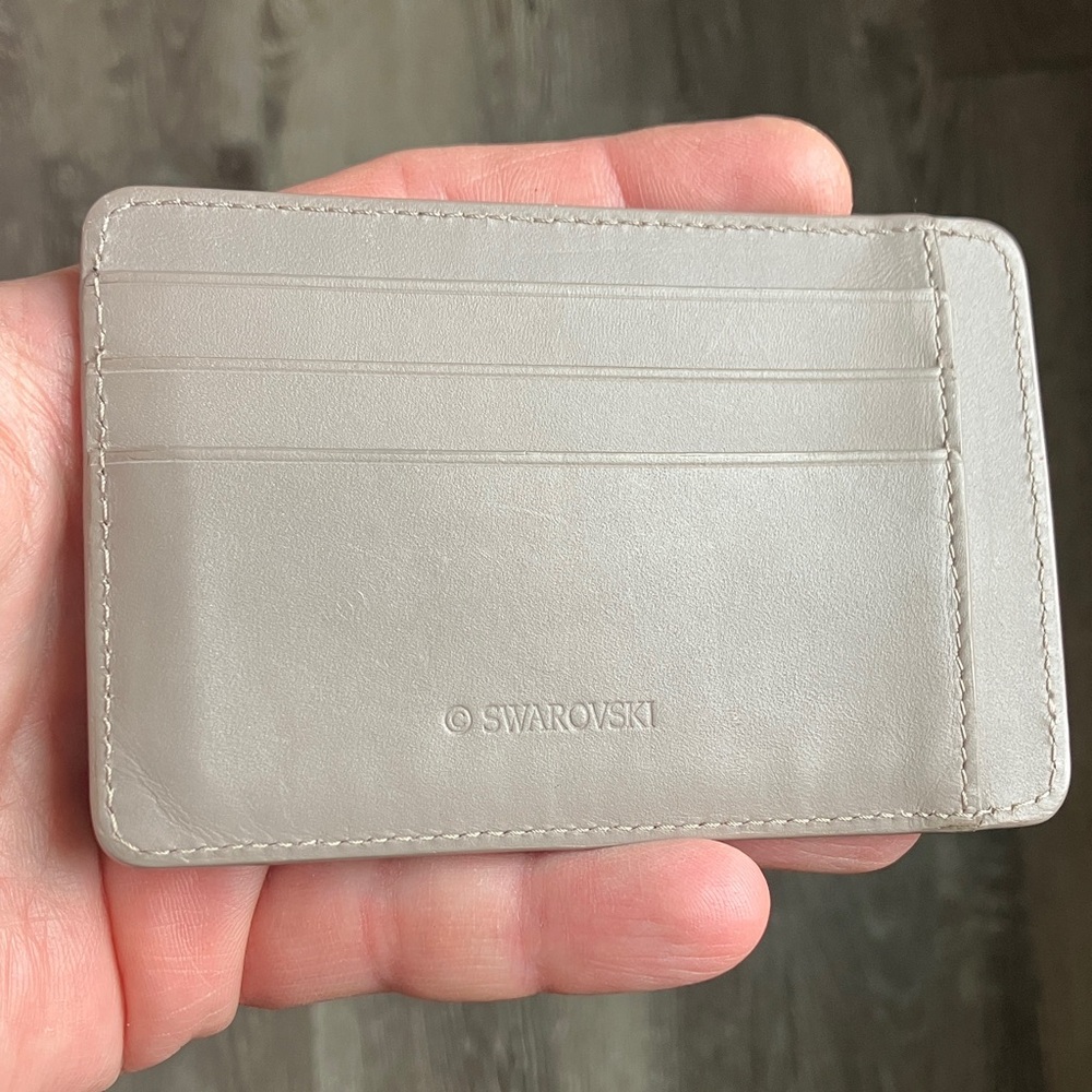 Swarovski taupe-colored leather card case/8 slots.